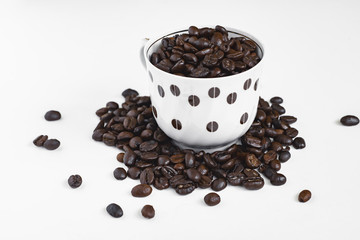 cup of coffee with beans on white background