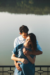 Young Caucasian Man Hugging Pregnant Wife