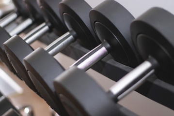 Fototapeta premium Rows of dumbbells in gym