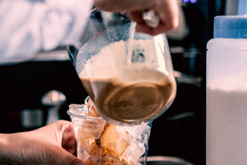 Barista making a take away coffee cup with coffee machine at cafe counter background : food and drink industry concept