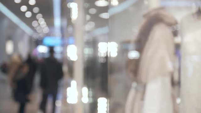 Profile of young woman in reflections of glass case