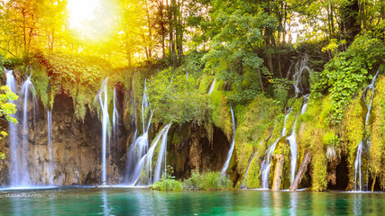 Close up of blue waterfalls in a green forest during daytime in Summer.Plitvice lakes, Croatia - Powered by Adobe