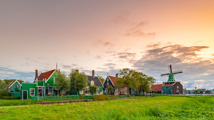 Evening street view on typically traditional Dutch house, windmill, historical architecture and bridge at the Zaanse Schans,