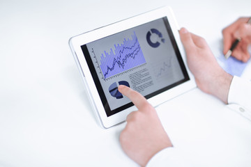 close up.businessman pointing with pen on a digital tablet screen.