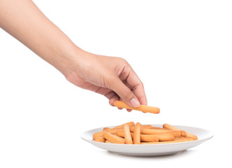 hand holding plate of crispy straw on white background. Biscuit sticks isolated on white background