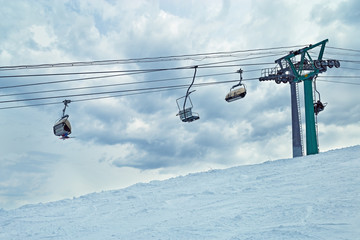 Ski lift against sky. Sheregesh ski resort. Active winter holidays.
