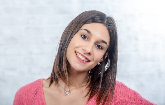 Young Smiling Brunette Woman With  Pink Sweater