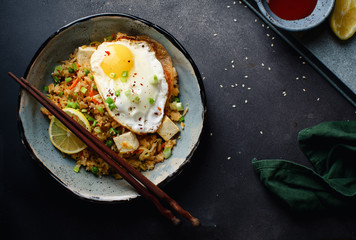Vegetarian fried rice with tofu, peas and vegetables. Asian cuisine, healthy lunch, copy space