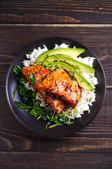 Salmon in honey-soy glaze with rice, spinach and avocado. overhead, vertical