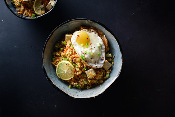 Vegetarian fried rice with tofu, peas and vegetables. Asian cuisine, healthy lunch, copy space