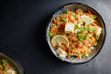 Vegetarian fried rice with tofu, peas and vegetables. Asian cuisine, healthy lunch, copy space