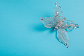 Christmas decoration  silver butterfly on a blue background