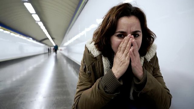 Hopeless and exhausted woman suffering depression and anxiety in subway tunnel in Work-life balance issues Negative body image Financial troubles and Stressful life events Mental health and loos of lo