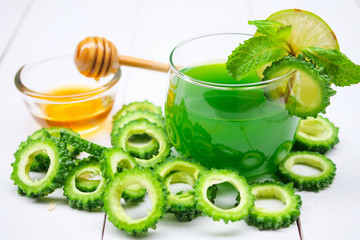 Juice of bitter gourd with raw and sliced bitter gourd.Healthy Herbal Drink