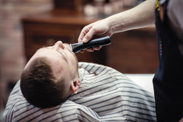 shaving beard trimmer at the hairdresser