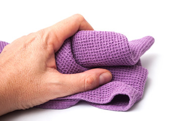 closeup of purple cleaning towel in hand on white background