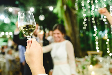 Close-up of champagne glass during the toast at a wedding.