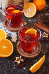 Healthy winter beverage. Cranberry fruit drink with oranges