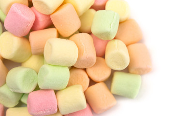 Pile of Colorful Fruit Flavored Marshmallows on a White Background