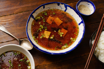 Japanese miso soup with tofu, wakame seaweed, spring onions and pepper flakes