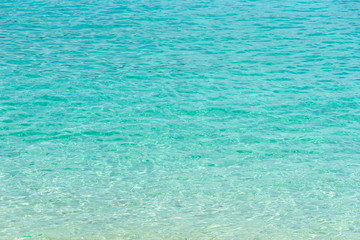 Tropical summer beach and transparent blue sea water background.