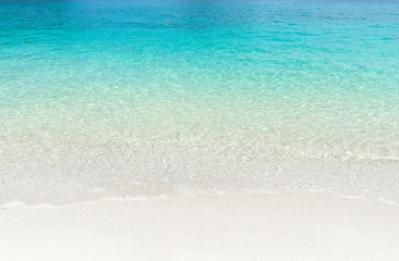 Tropical summer beach and transparent blue sea water background.
