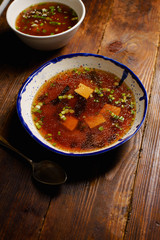 Japanese miso soup with tofu, wakame seaweed, spring onions and pepper flakes