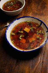 Japanese miso soup with tofu, wakame seaweed, spring onions and pepper flakes