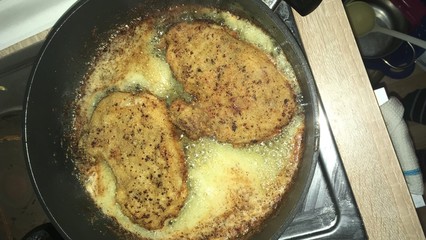 Chops breaded and fried in a pan with butter