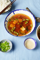 Japanese miso soup with tofu, wakame seaweed, spring onions and pepper flakes