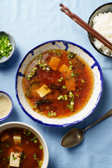 Japanese miso soup with tofu, wakame seaweed, spring onions and pepper flakes
