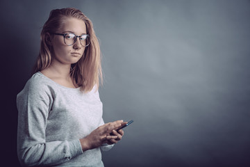 Portrait of a young girl with a phone