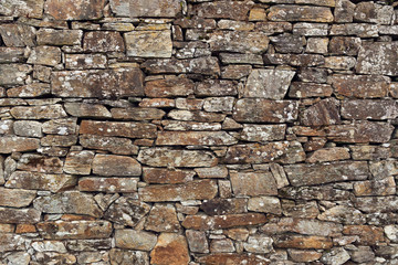 Stone wall background. Ancient wall of dry masonry. Stone wall texture in the historic city of Santiago de Compostela