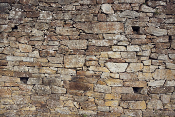 Stone wall background. Ancient wall of dry masonry. Stone wall texture in the historic city of Santiago de Compostela