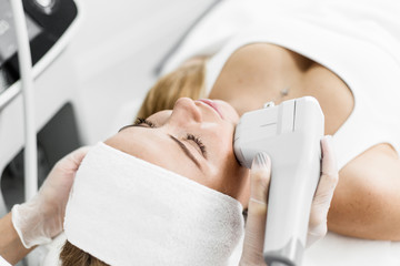 Beautiful girl lying in the Spa salon for facial rejuvenation, side view