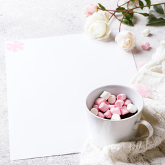 Creative winter natural composition with flowers, a cup of hot chocolate and marshmallows, with decoration pink color Flat lay Greeting card copy space.Christmas background Festive Drink concept.