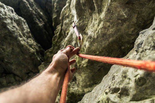 The Climber's Hand Clicks The Rope In Carbine. Rock Climbing