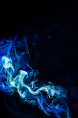 Fototapeta premium blurry smoke abstract background blue color on black night . free form swirl flowing fog in the air .