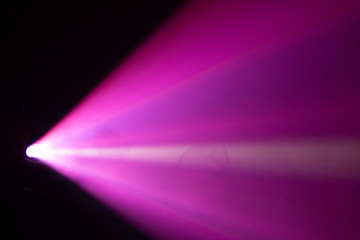 blur beautiful pink color wide lens projector with light beam for movie and cinema at night . smoke texture spotlight . effects screening for multimedia . black background .