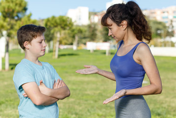 Mother berating son outdoors