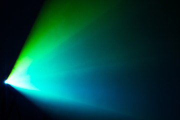 beautiful green and blue shade color wide lens projector with light beam for movie and cinema at night . smoke texture spotlight . screening for multimedia black background .