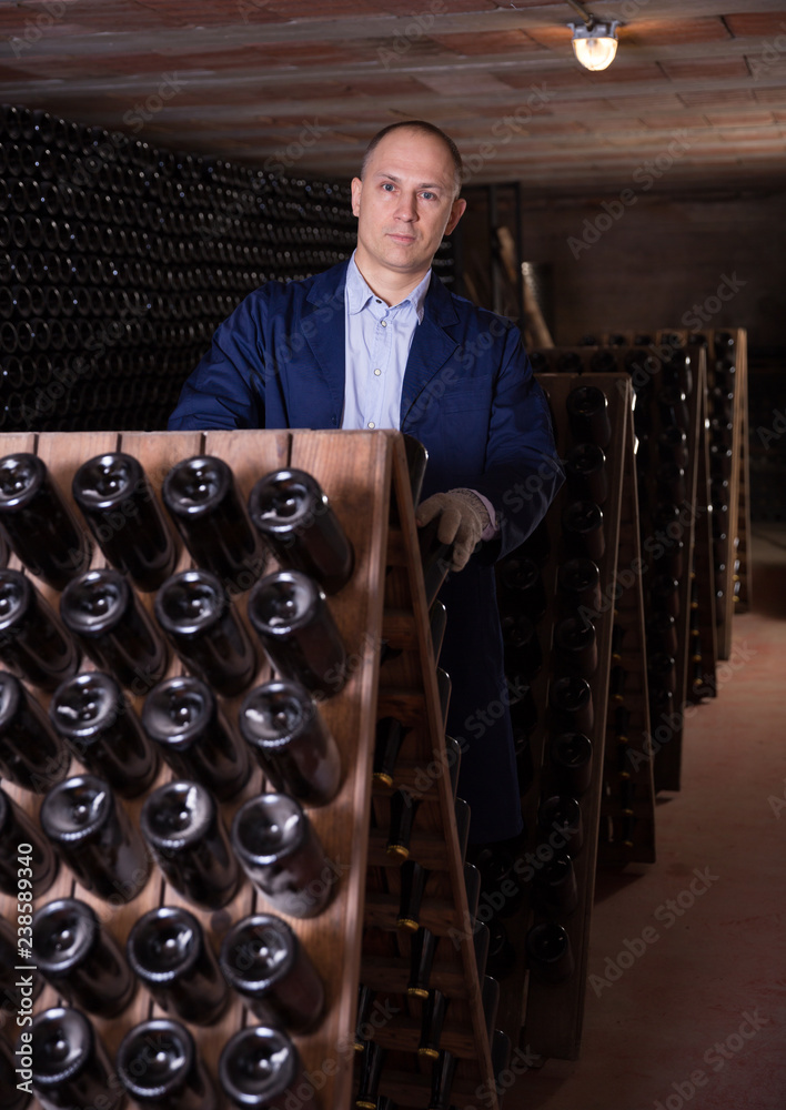 Sticker Winemaker checking bottles with wine