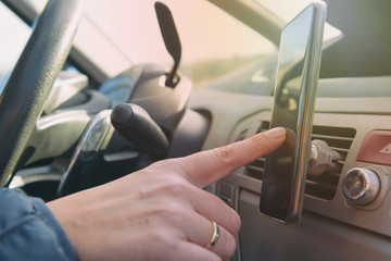 Woman using smort phone while driving the car