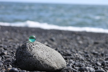 Beach of Stones in Island with Green Glassbowl Zen