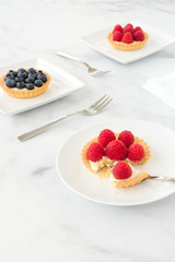Blueberry and Raspberry Tartlets on Marble Background