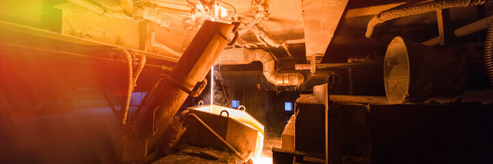 Process of fiberglass production at manufacture background with industry equipment