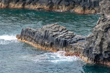 Volcanic basalt columns into the Atlantic Ocean on the coastline of La Palma Island