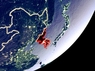 Korea from space on model of Earth at night. Very fine detail of the plastic planet surface and visible bright city lights.