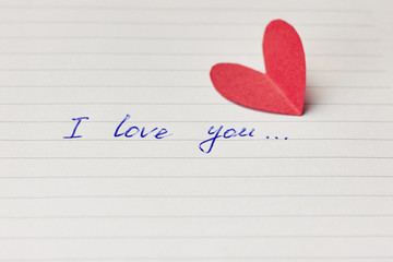 Paper page of notepad with sign I love you and red paper heart