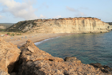 Fototapeta na wymiar Lonely mediterranean beach between the white sea-cliffs